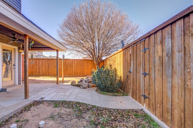 view of yard featuring a patio and ceiling fan