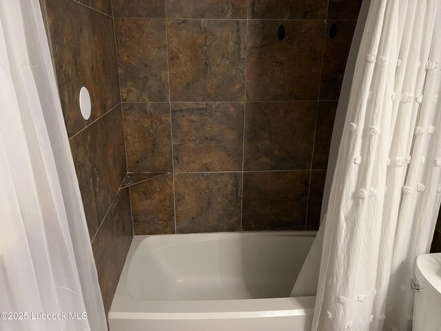 8601 Memphis Dr Unit B-40, Lubbock, TX 79423 - bathroom featuring toilet and shower / bath combo with shower curtain
