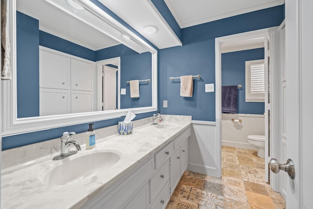 bathroom featuring vanity, ornamental molding, and toilet