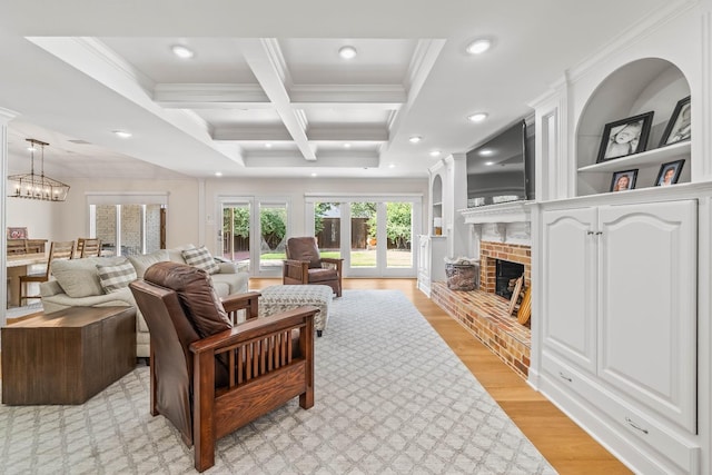 living room featuring coffered ceiling, beam ceiling, light hardwood / wood-style flooring, and ornamental molding