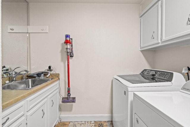 laundry room featuring cabinets, sink, and independent washer and dryer