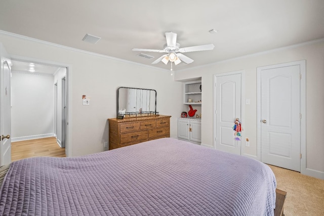 carpeted bedroom with crown molding and ceiling fan