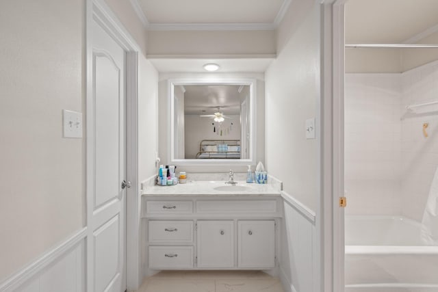 bathroom with crown molding, ceiling fan, vanity, and shower / bath combination