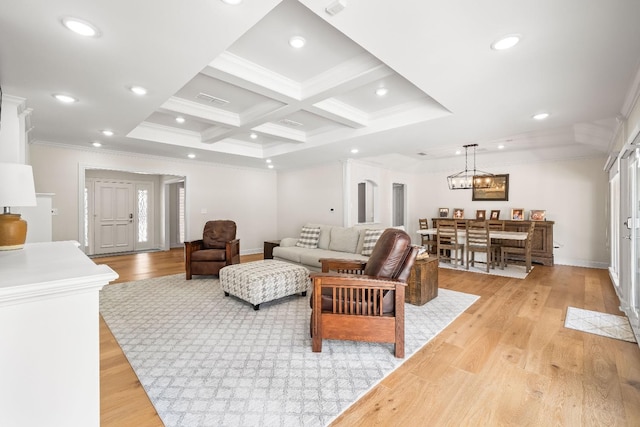 living room featuring ornamental molding, coffered ceiling, and light hardwood / wood-style floors