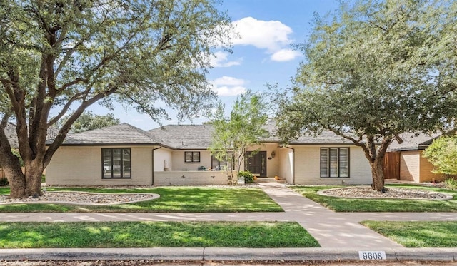 ranch-style home with a front yard