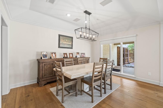 dining room with ornamental molding and hardwood / wood-style floors