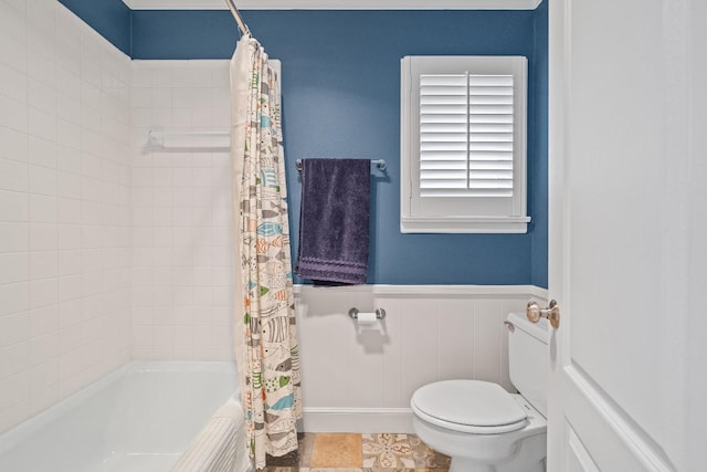 bathroom with shower / bath combination with curtain and toilet