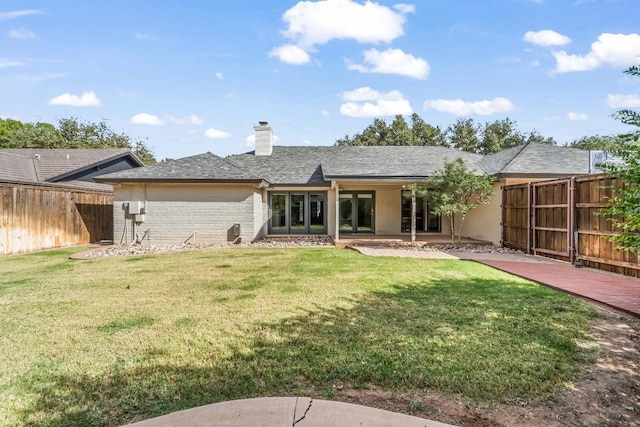 back of house with a yard