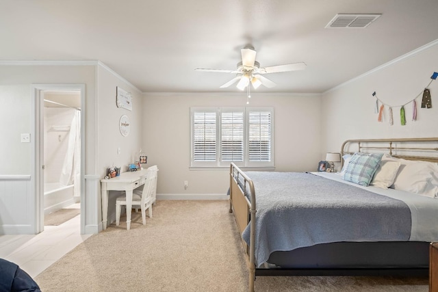 carpeted bedroom with crown molding, ceiling fan, and ensuite bathroom