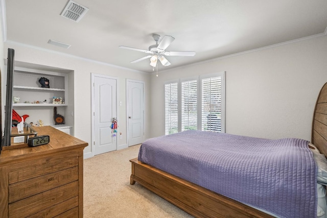 carpeted bedroom with ornamental molding and ceiling fan