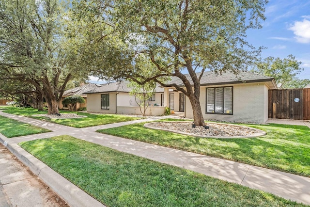 ranch-style home featuring a front yard