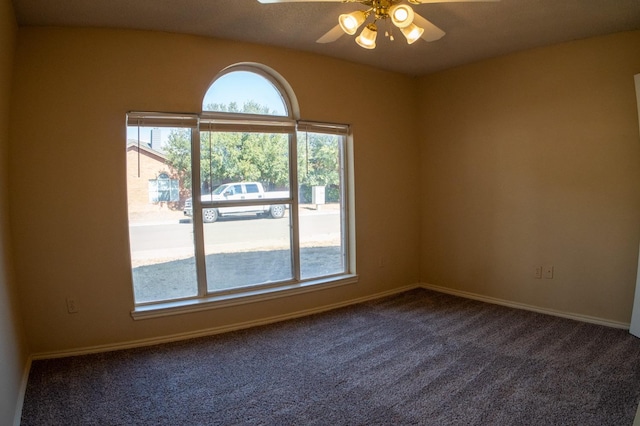 carpeted spare room with ceiling fan