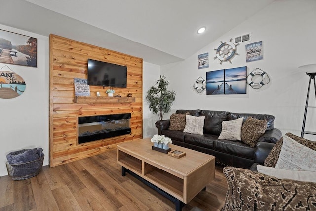 living room with wood-type flooring and lofted ceiling