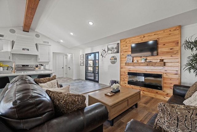 living room featuring dark hardwood / wood-style flooring, vaulted ceiling with beams, sink, and french doors