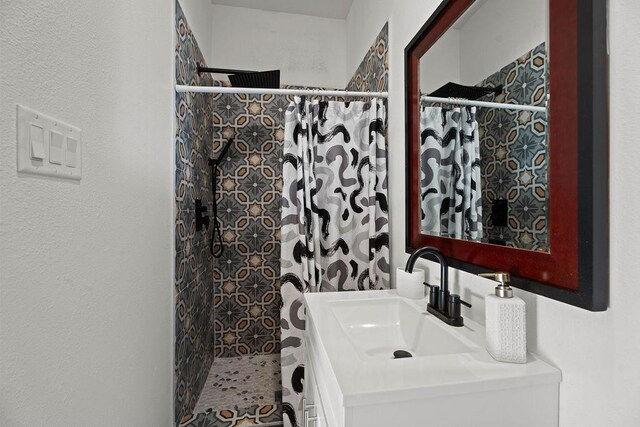 bathroom with vanity and a shower with shower curtain