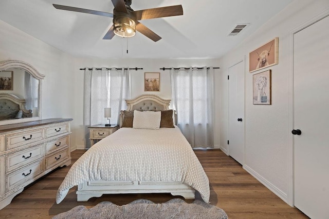 bedroom with dark hardwood / wood-style floors and ceiling fan