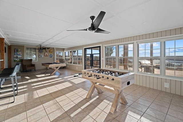 recreation room with tile patterned floors and ceiling fan