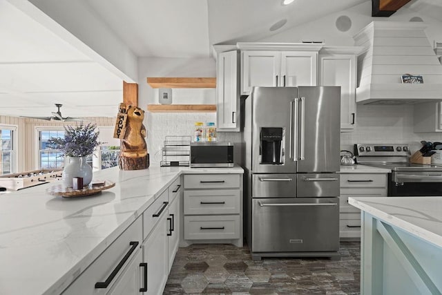 kitchen featuring white cabinetry, appliances with stainless steel finishes, light stone countertops, and tasteful backsplash