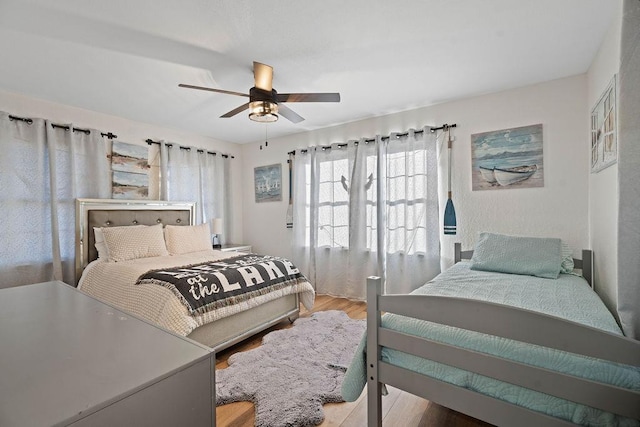 bedroom featuring light wood-type flooring and ceiling fan