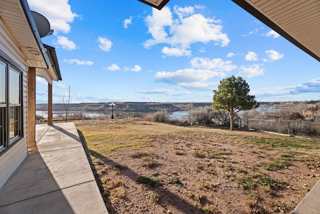 view of yard with a patio and a water view