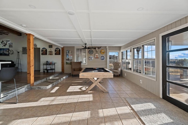 game room with ceiling fan, light tile patterned floors, and wooden walls