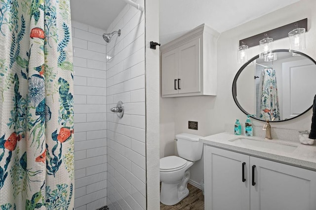 bathroom featuring a shower with curtain, vanity, toilet, and hardwood / wood-style flooring