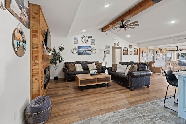 living room with ceiling fan, wood-type flooring, and vaulted ceiling with beams