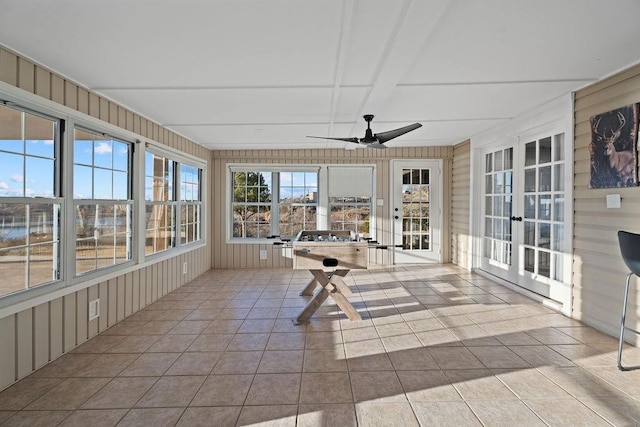 unfurnished sunroom with ceiling fan