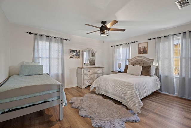 bedroom with ceiling fan and light wood-type flooring