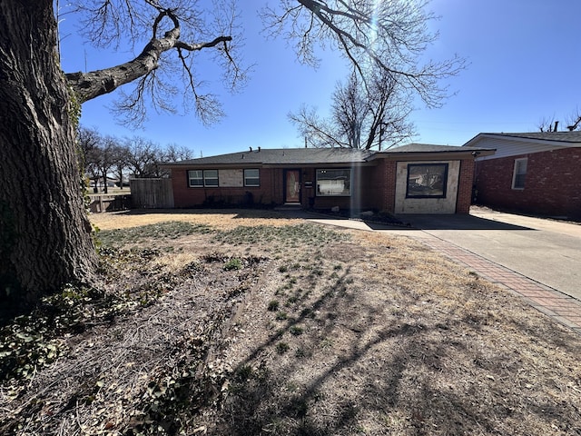 ranch-style home with brick siding and fence