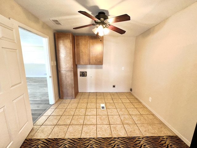 unfurnished room with ceiling fan, visible vents, and baseboards