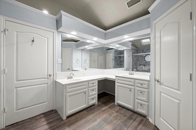 bathroom with walk in shower, ornamental molding, vanity, and hardwood / wood-style flooring