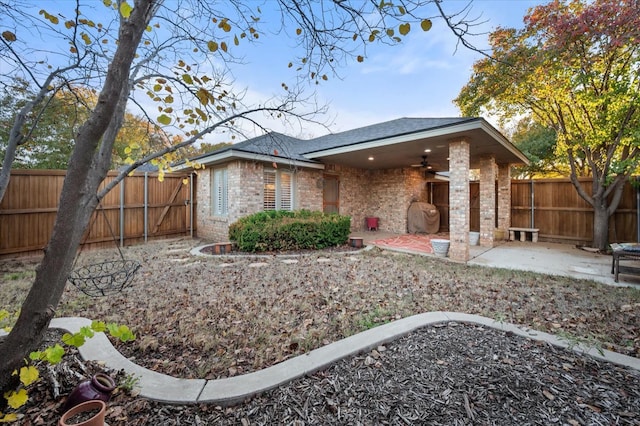 back of house with ceiling fan and a patio