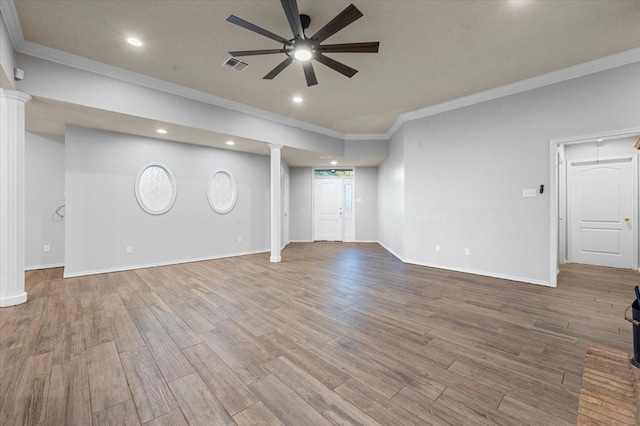 interior space with ceiling fan, wood-type flooring, decorative columns, and ornamental molding