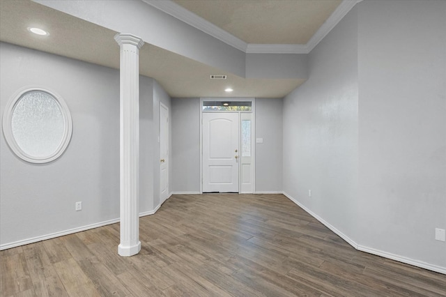 entryway featuring decorative columns, wood-type flooring, and ornamental molding