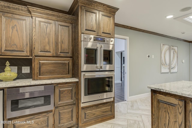 4517 9th St, Lubbock, TX 79416 - kitchen with double oven, ornamental molding, baseboards, light stone counters, and recessed lighting