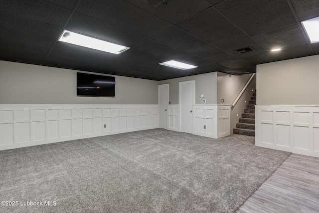 4517 9th St, Lubbock, TX 79416 - finished basement featuring a drop ceiling, stairway, and wood finished floors