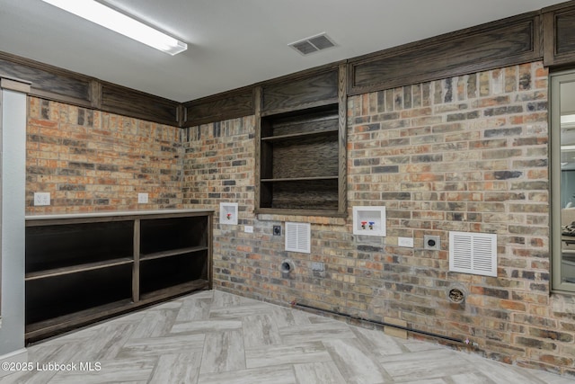 4517 9th St, Lubbock, TX 79416 - unfurnished living room featuring brick wall
