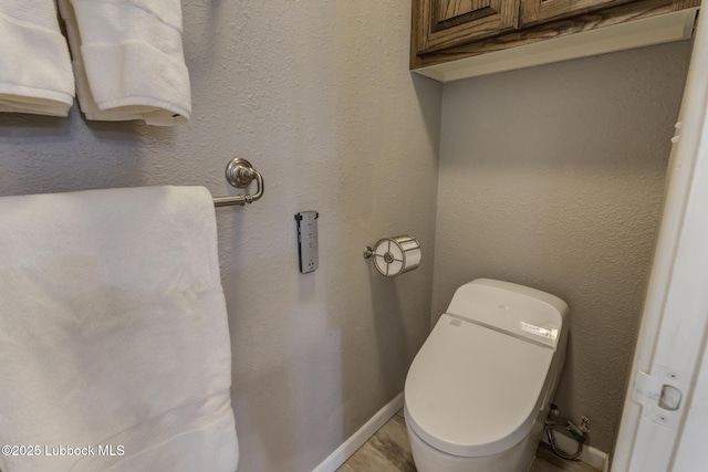 4517 9th St, Lubbock, TX 79416 - bathroom featuring baseboards and toilet