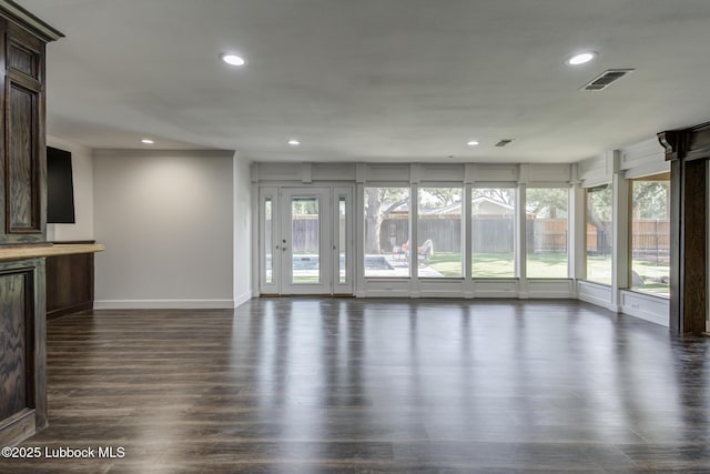 4517 9th St, Lubbock, TX 79416 - unfurnished living room featuring recessed lighting, baseboards, plenty of natural light, and dark wood-type flooring