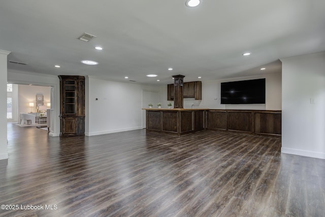 4517 9th St, Lubbock, TX 79416 - unfurnished living room featuring recessed lighting, baseboards, dark wood-style flooring, ornamental molding, and ornate columns