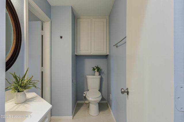 4517 9th St, Lubbock, TX 79416 - bathroom with toilet, tile patterned flooring, baseboards, and vanity