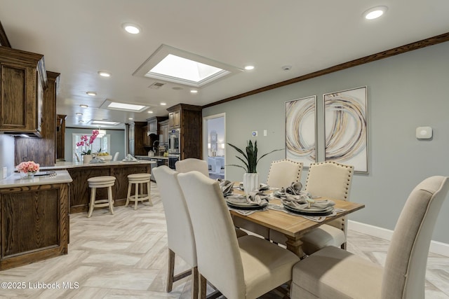 4517 9th St, Lubbock, TX 79416 - dining area featuring a skylight, recessed lighting, crown molding, and baseboards