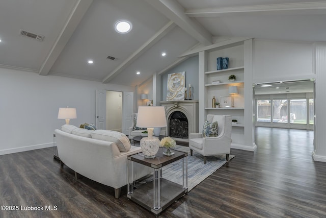 4517 9th St, Lubbock, TX 79416 - living room with dark wood-style floors, a fireplace with raised hearth, built in shelves, recessed lighting, and baseboards