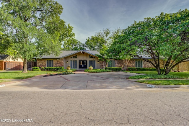 4517 9th St, Lubbock, TX 79416 - mid-century home featuring fence and board and batten siding