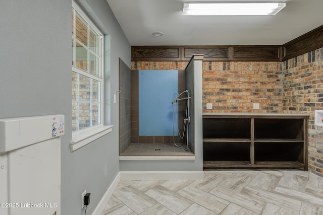 4517 9th St, Lubbock, TX 79416 - bathroom with tiled shower, baseboards, and plenty of natural light