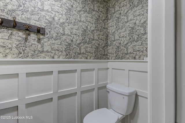 4517 9th St, Lubbock, TX 79416 - bathroom with a wainscoted wall, a decorative wall, toilet, and wallpapered walls