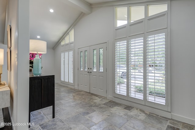 4517 9th St, Lubbock, TX 79416 - entrance foyer featuring stone tile floors, healthy amount of natural light, baseboards, beam ceiling, and high vaulted ceiling
