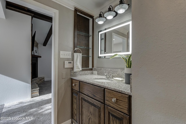 4517 9th St, Lubbock, TX 79416 - bathroom featuring vanity, a fireplace, ornamental molding, and a textured wall