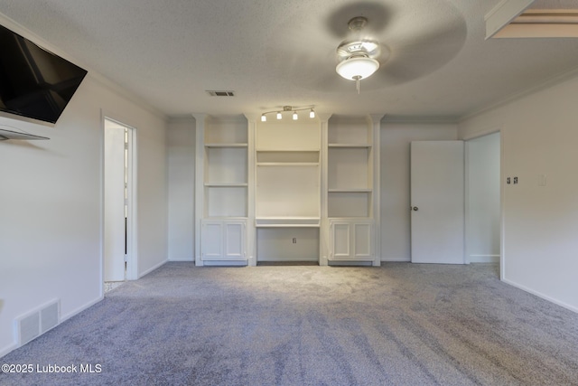 4517 9th St, Lubbock, TX 79416 - unfurnished living room with carpet flooring, ornamental molding, baseboards, and a textured ceiling